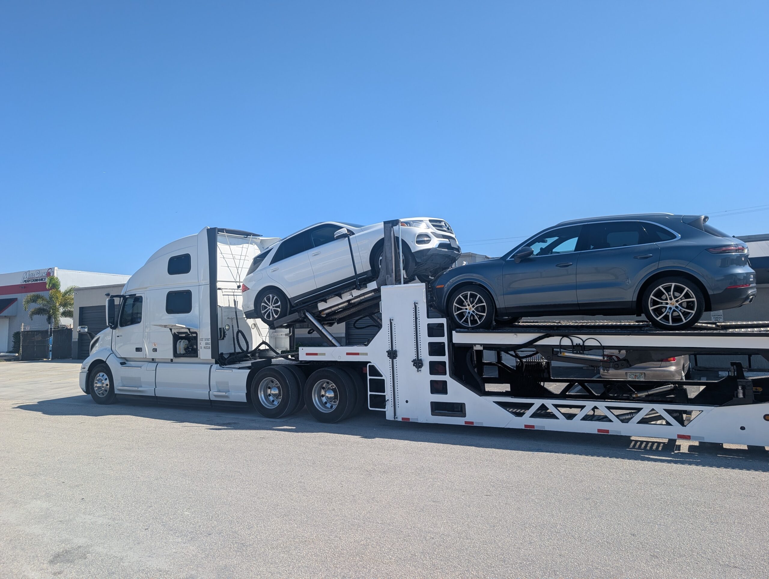 Lightning Carrier auto transport truck at staging facility